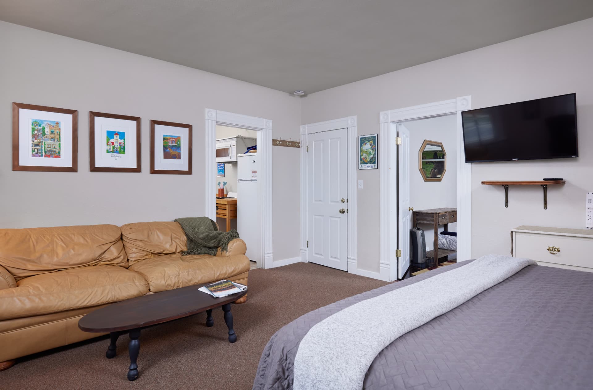 The Vineyard living area with tan leather sofa looking toward the kitchen