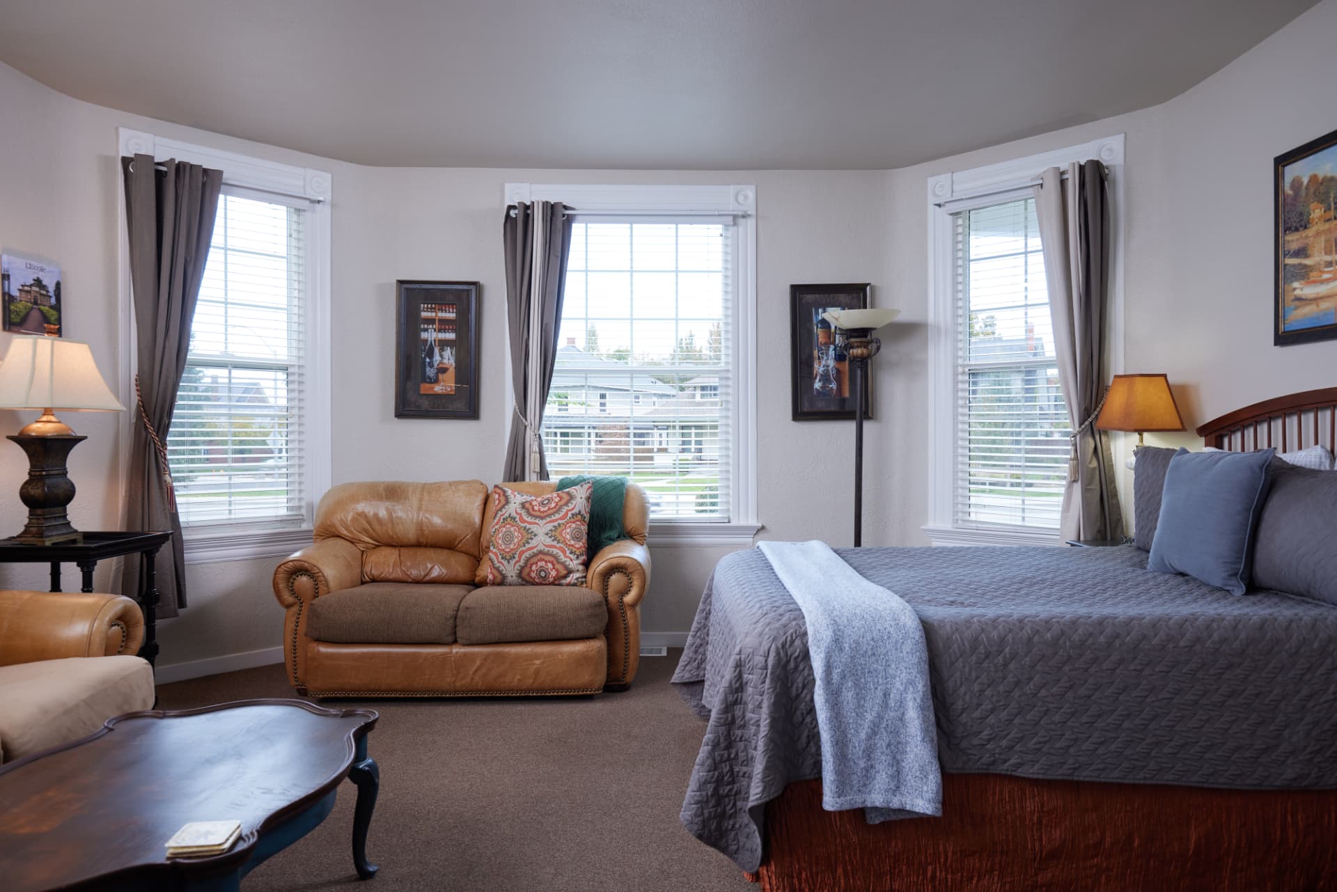 The Turret sitting room with three turret windows and a king bed