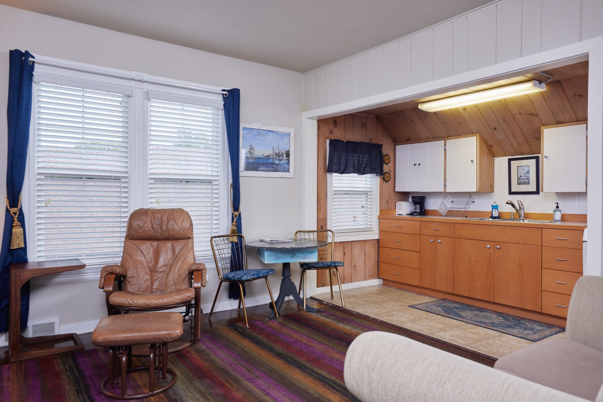 The Harbor living and kitchen area with pine paneling and a dining table