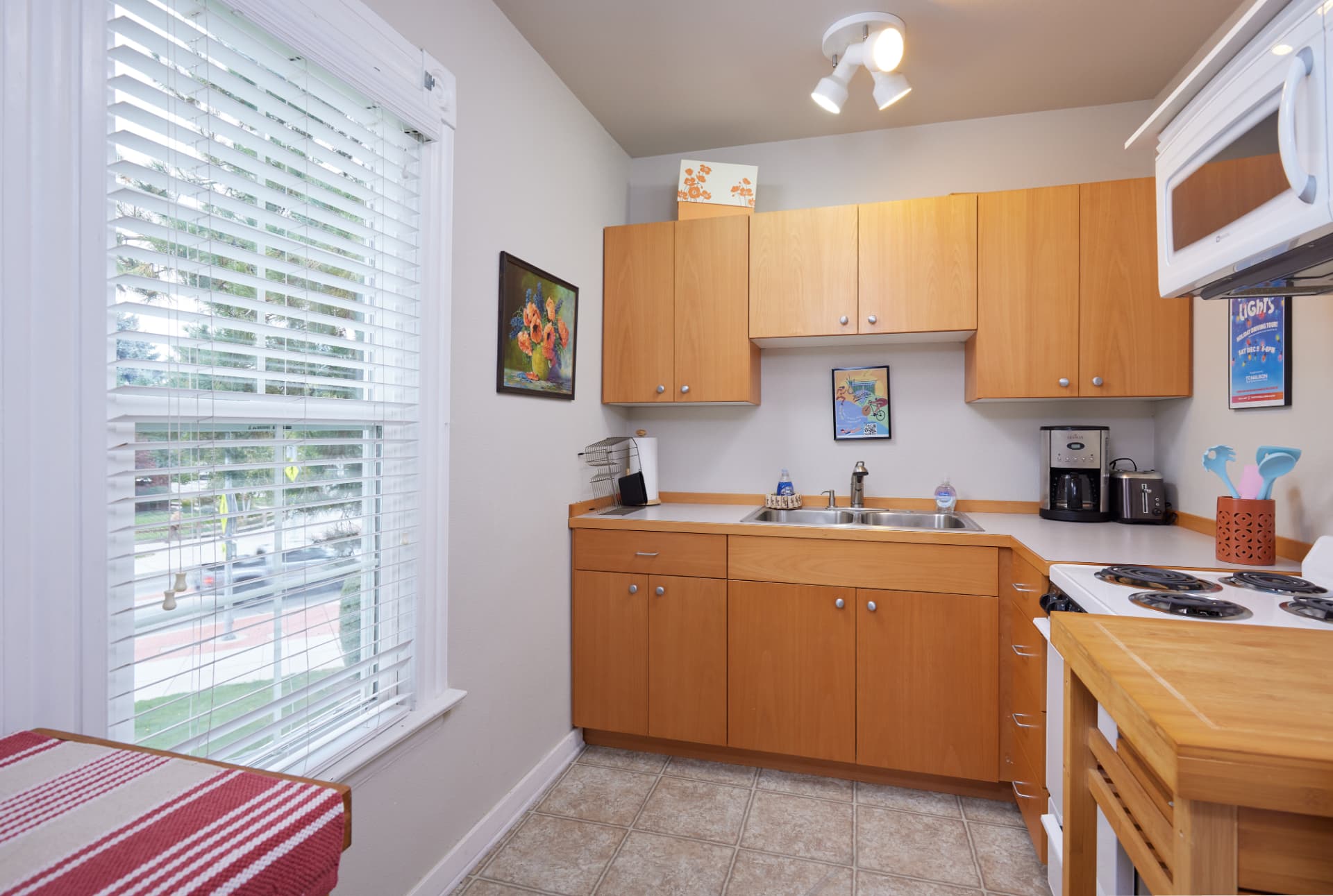 The Vineyard kitchen with light wood cabinets, range and window