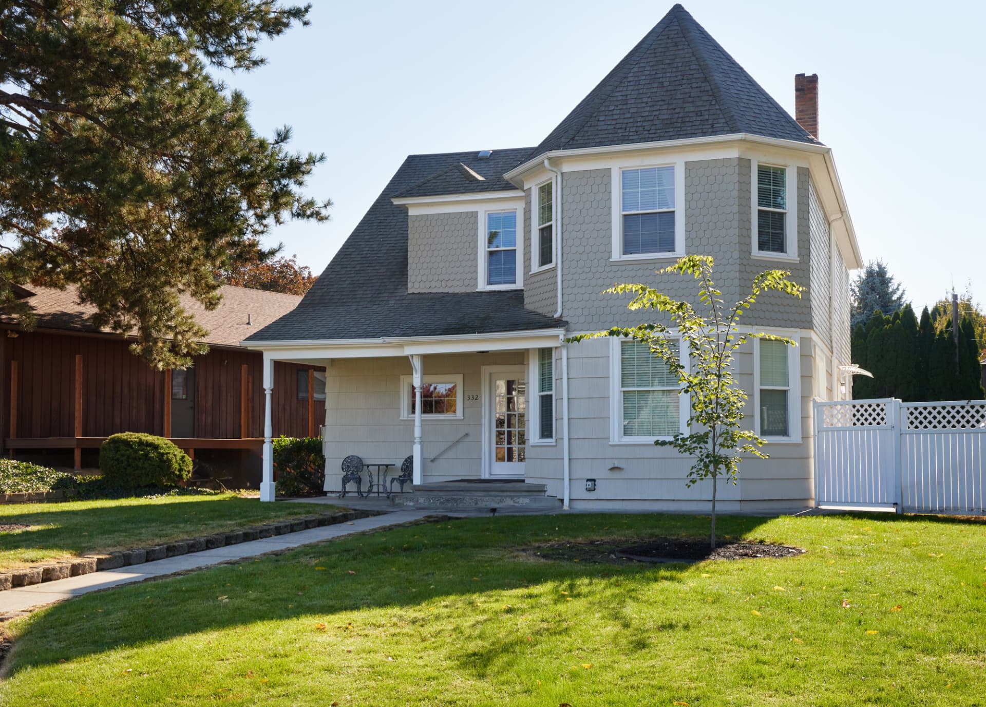 Poplar Places, a shingled Victorian house with a turret and covered porch in Walla Walla