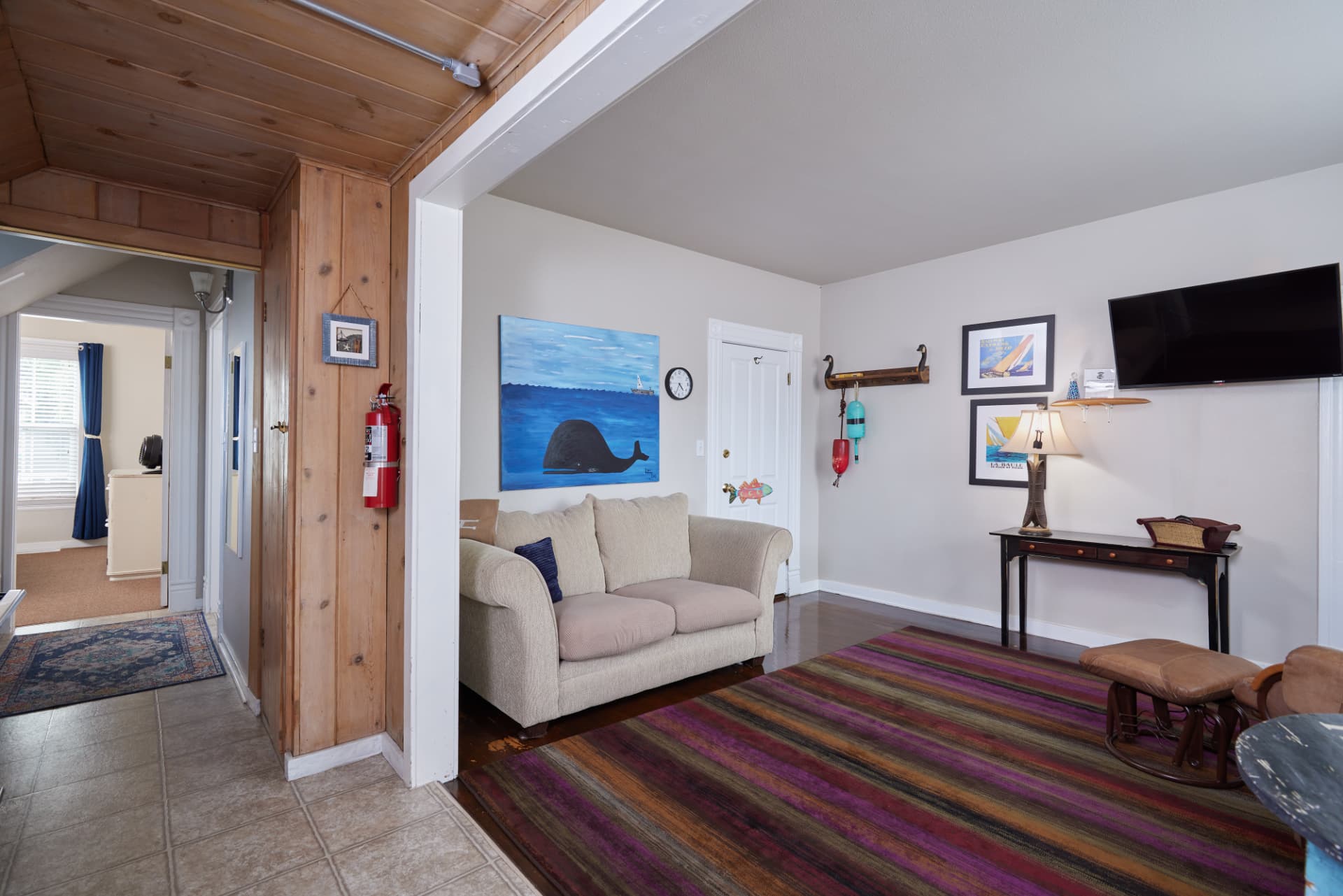 The Harbor hallway looking past the whale painting toward the bedroom