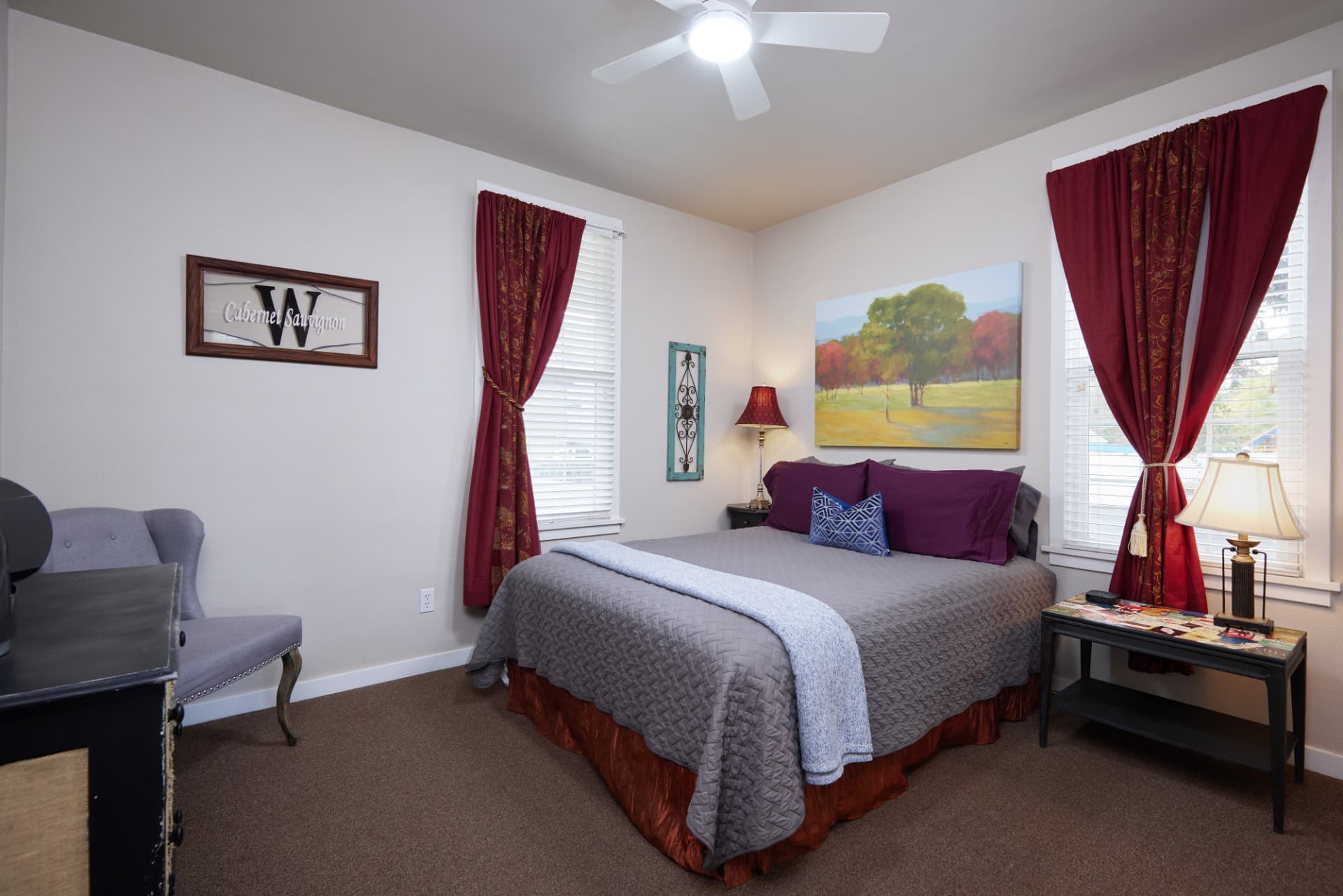 The Turret second bedroom with a queen bed and garnet curtains
